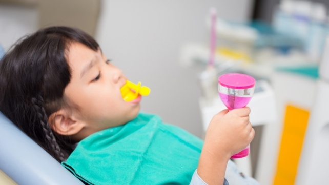 Child receiving fluoride treatment