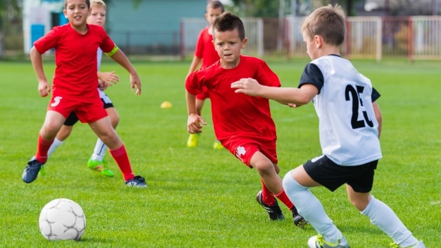 Children with athletic mouthguards playing soccer