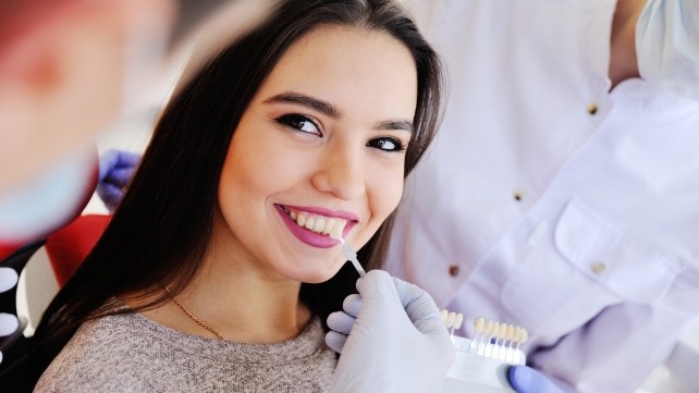Cosmetic dentistry patient's smile compared to porcelain veneer shade option