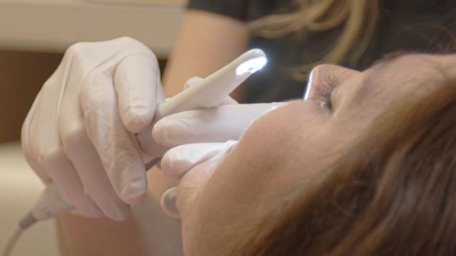 Dental patient receiving teeth whitening