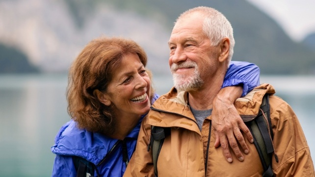 Man and woman smiling after dental implant tooth replacement