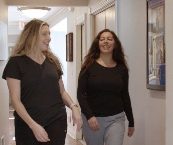 Two smiling dental team members at the dental office